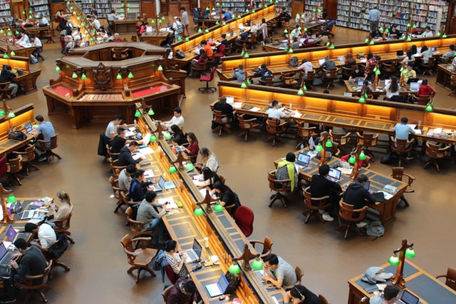 Top view of students studying in library.